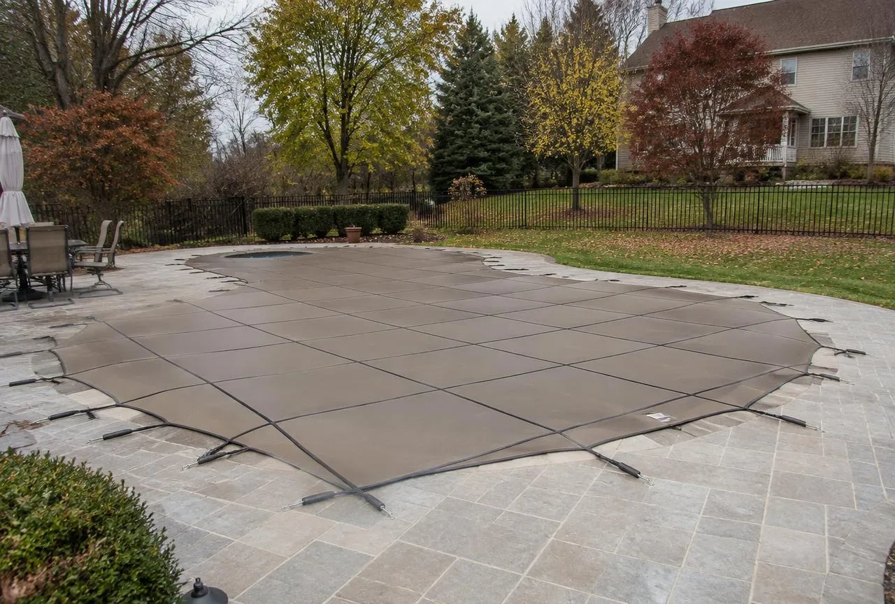 Custom mesh pool safety cover installed on an inground pool in fall – pool covers in Cincinnati, Northern Kentucky & Hamilton OH